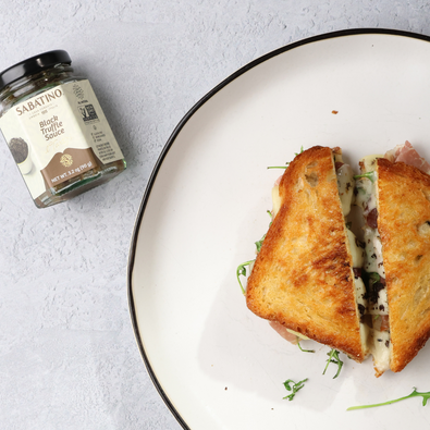 Grilled Cheese with Black Truffle Sauce, Prosciutto, and Arugula